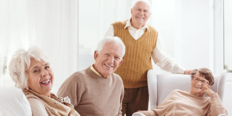 Group of Happy Seniors Smiling Together at Memory Care Home